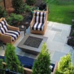 Custom stone fire pit with outdoor seating designed by Apex Outdoors