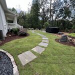 Stone pathway installation by Apex Outdoors for outdoor living spaces