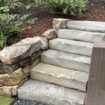 Custom stone stairs by Apex Outdoors creating safe garden access