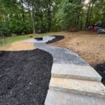 Retaining wall construction by Apex Outdoors in North Georgia, enhancing outdoor living spaces and curb appeal