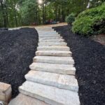 Flagstone walkway installation by Apex Outdoors for stylish curb appeal